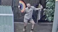 Dancing zookeeper waves a fan around during a livestream at Melbourne Zoo