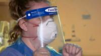 Care home staff member with visor