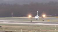 Plane looking like it's landing sideways on a runway