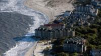 A new photography book captures the environmental threat to America's coastal region.