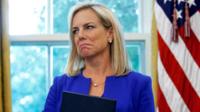 Former US Homeland Security Secretary Kirstjen Nielsen holding an executive order on immigration policy