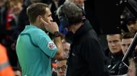A referee consults with a video assistant referee