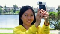Girl holding mobile phone camera