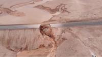 Road in desert washed away