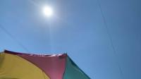 A colourful umbrella offers some shade from the sun