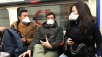 People on a tube wearing face masks