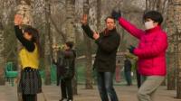 John Sudworth dancing with two Chinese women