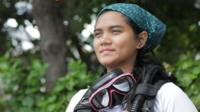 Woman diver with scuba diving gear.