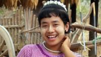 Burmese woman has tucks her hair behind her ears to show she is ready to date.