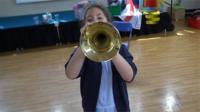 Girl blowing trumpet