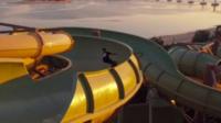 Three skateboarders have a go at skating some of the rides at a waterpark in Dubai while it is closed for cleaning.