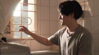 Man looks out of basement window