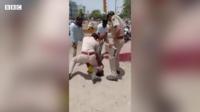 Police restraining a man