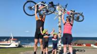 Jones family holding bikes