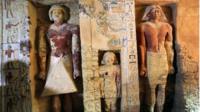 Coloured statues in alcoves inside the tomb