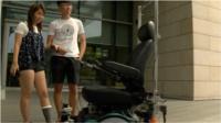 Passengers wait for a driverless taxi