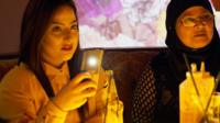 People using phones while out for dessert