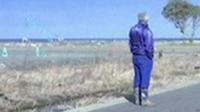 Tomioka's only resident stands looking out to sea.