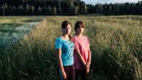 Sisters standing in the fields