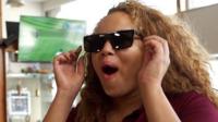 Woman wearing sunglasses with surprised expression