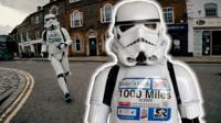 A stormtrooper runs through a town