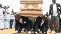 Pallbearers carrying a coffin on the backs