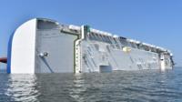 The US Coastguard has made contact with four missing crew members of a cargo ship that capsized.