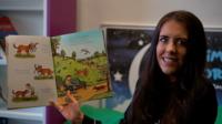 Teacher holds story book