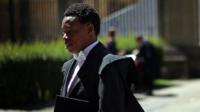 An Oxford University student arrive at the Exam Schools building