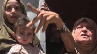 Mosul residents gesture as they speak to the camera - 1 July 2017