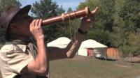 Man blows into a horn