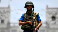 soldier stands guard outside St. Anthony's Shrine in Colombo on April 25, 2019, following a series of bomb blasts targeting churches and luxury hotels on the Easter Sunday in Sri Lanka. - All of Sri Lanka's Catholic churches have been ordered to stay closed and suspend services until security improves after deadly Easter bombings, which killed at least 359 people and wounded hundreds, a senior priest told AFP on April 25. (Photo by Jewel SAMAD / AFP) (Photo credit should read JEWEL SAMAD/AFP/Getty Images)