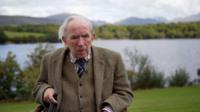 Ian Hamilton sitting next to a Scottish Loch