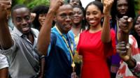 BBC Pidgin team raise their arms together