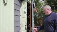 Man entering shed