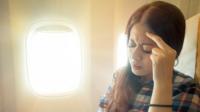 Worried woman on plane