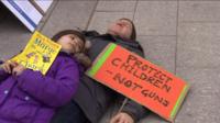 A man and child lay down as part of the "die-in"