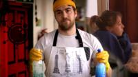 Man with cleaning bottles
