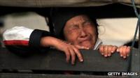 An Ethnic Hmong refugee sits inside a police truck during the operation to deport Hmong from Thailand