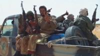 Malian men sat on a truck
