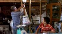 A man weighing his household rubbish