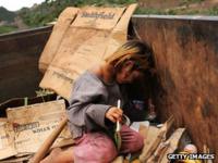 A street child plays in a dumpster in Honduras