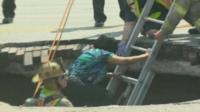 Woman escapes sinkhole