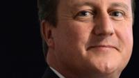 Britain"s Prime Minister David Cameron listens to speeches on the first day of the Conservative Party annual conference in Manchester northern England