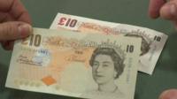 A counterfeit £10 against a real one