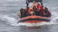 Migrants being brought ashore