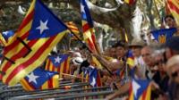 Catalonia separatist supporters wave flags outside parliament