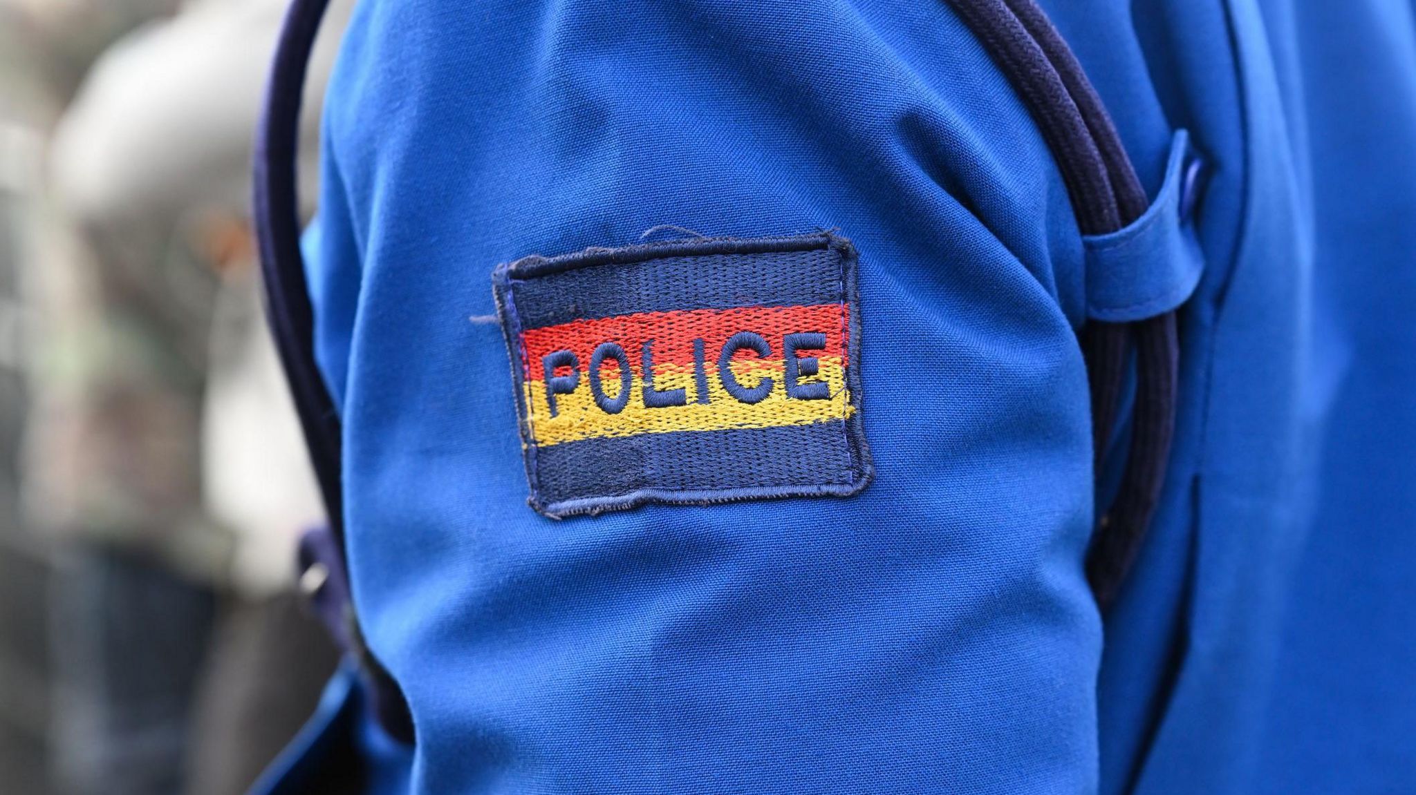 The chevron Police on the sleeve of a blue police suit in Nairobi. Kenya