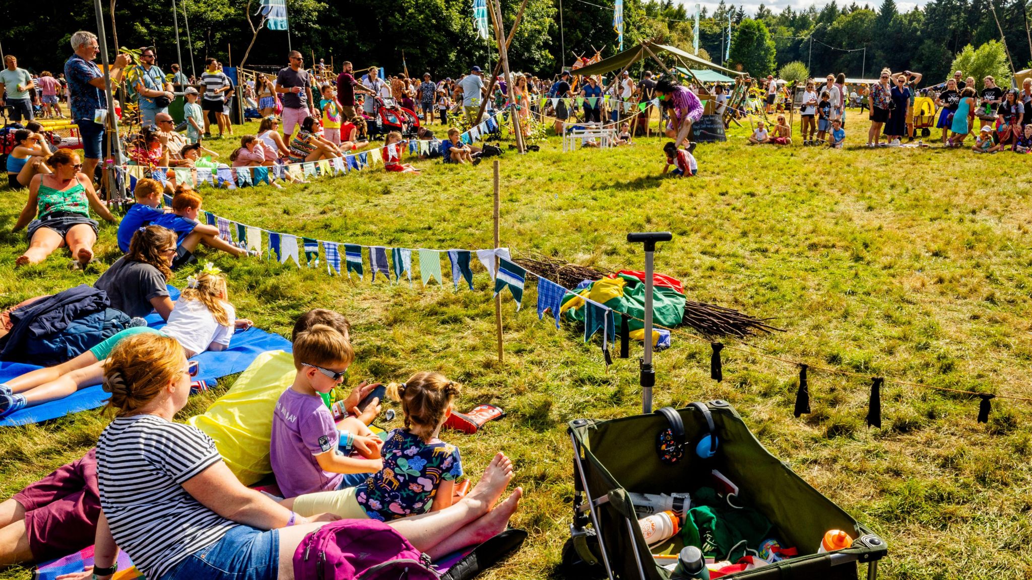 Families sitting on the grass outside