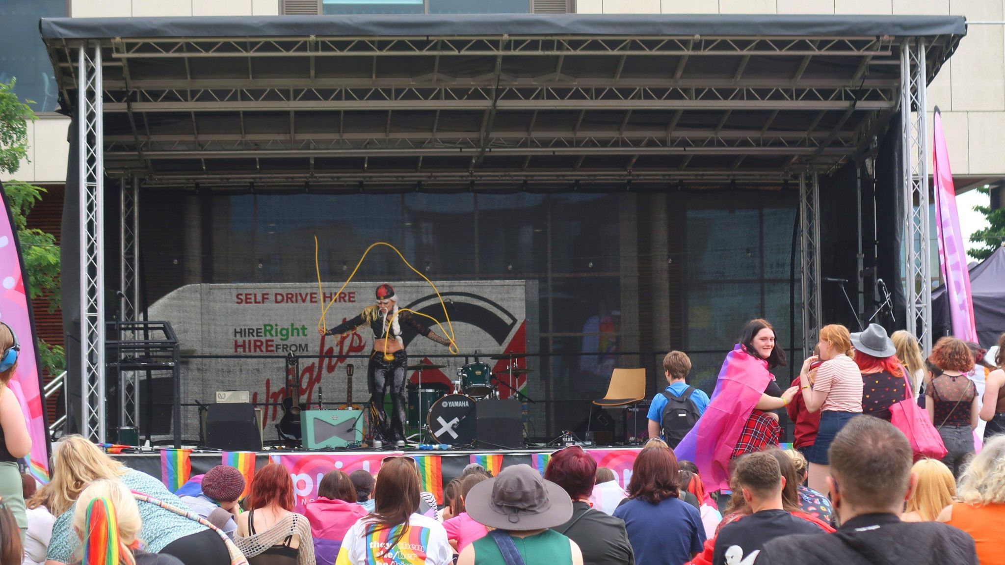 Stage with a drag queen entertaining a crowd